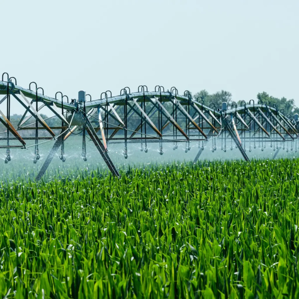 irrigation system spraying farm field with recycled liquid waste